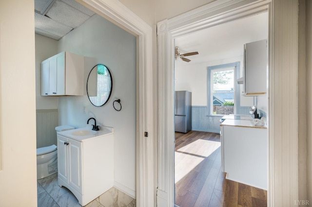 838 Rivermont Ave, Lynchburg, VA 24504 - bathroom featuring a wainscoted wall, vanity, and wood finished floors