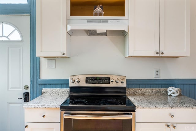 838 Rivermont Ave, Lynchburg, VA 24504 - kitchen featuring stainless steel range with electric stovetop, under cabinet range hood, white cabinets, and light stone countertops