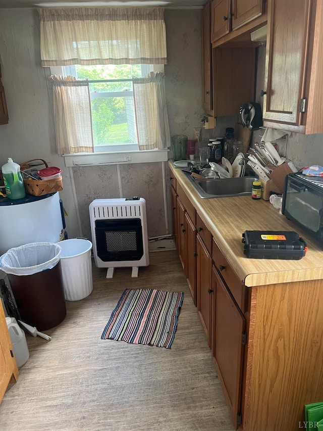3200 Pocket Rd, Hurt, VA 24563 - kitchen featuring heating unit, light countertops, and brown cabinetry