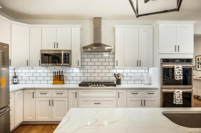 336 Somerset Dr, Appomattox, VA 24522 - kitchen featuring stainless steel appliances, wall chimney exhaust hood, white cabinets, and wood finished floors