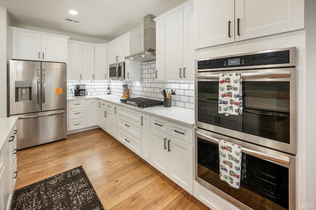 336 Somerset Dr, Appomattox, VA 24522 - kitchen featuring stainless steel appliances, wall chimney range hood, white cabinets, backsplash, and recessed lighting
