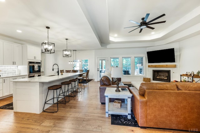336 Somerset Dr, Appomattox, VA 24522 - living area with recessed lighting, ceiling fan, light wood-type flooring, a fireplace, and a chandelier