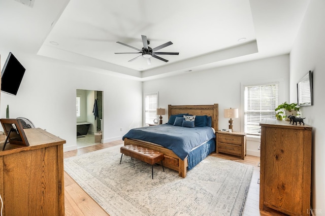 336 Somerset Dr, Appomattox, VA 24522 - bedroom with a raised ceiling, light wood-type flooring, ensuite bathroom, and ceiling fan