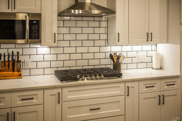 336 Somerset Dr, Appomattox, VA 24522 - kitchen featuring stainless steel appliances, wall chimney range hood, tasteful backsplash, white cabinets, and light stone counters