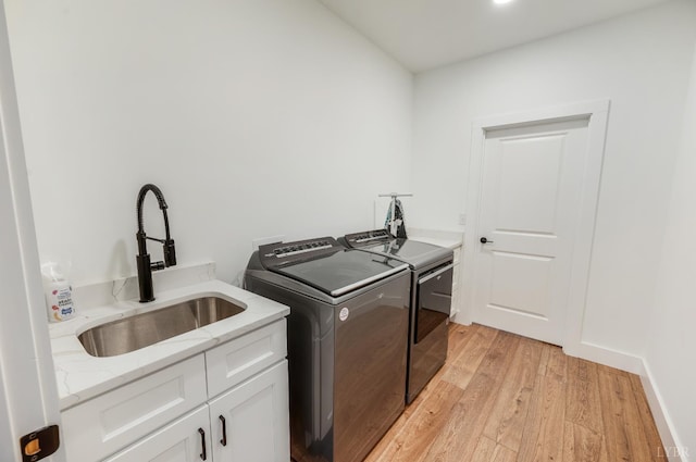 336 Somerset Dr, Appomattox, VA 24522 - laundry area featuring cabinet space, washing machine and clothes dryer, and light wood finished floors