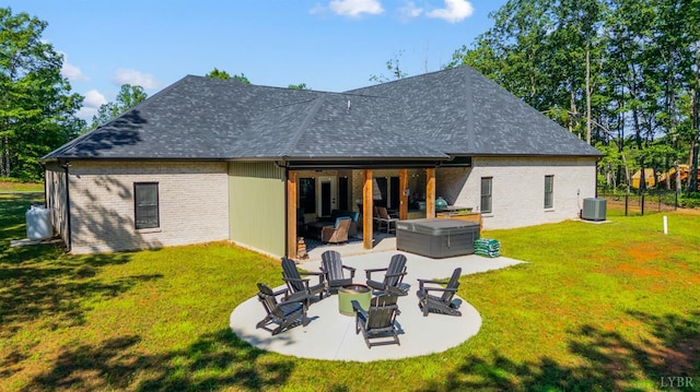 336 Somerset Dr, Appomattox, VA 24522 - rear view of property featuring a hot tub, a fire pit, a patio area, a yard, and brick siding