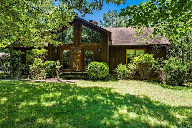 239 Briarcliff Ln, Madison Heights, VA 24572 - view of front of house featuring a front yard, a chimney, and roof with shingles