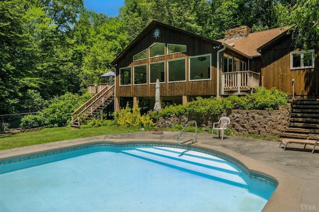 239 Briarcliff Ln, Madison Heights, VA 24572 - rear view of house featuring stairway, a wooden deck, a chimney, and an outdoor pool