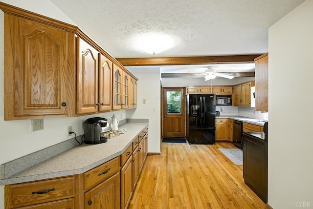 239 Briarcliff Ln, Madison Heights, VA 24572 - kitchen with black appliances, light wood-style flooring, brown cabinetry, light countertops, and beam ceiling