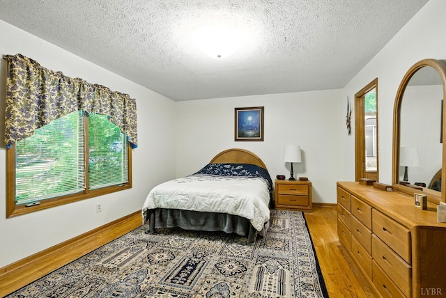 239 Briarcliff Ln, Madison Heights, VA 24572 - bedroom with light wood-type flooring and a textured ceiling