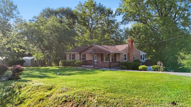 2294 High Peak Rd, Monroe, VA 24574 - view of front of home featuring a front yard, a chimney, brick siding, and a storage shed