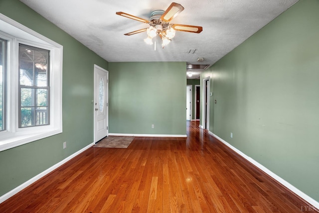 2294 High Peak Rd, Monroe, VA 24574 - unfurnished room with wood finished floors, a ceiling fan, and a textured ceiling