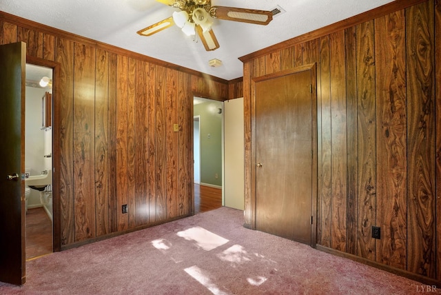 2294 High Peak Rd, Monroe, VA 24574 - unfurnished bedroom featuring wooden walls, carpet floors, and a ceiling fan