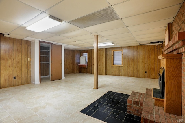 2294 High Peak Rd, Monroe, VA 24574 - basement with wood walls, a drop ceiling, and a brick fireplace