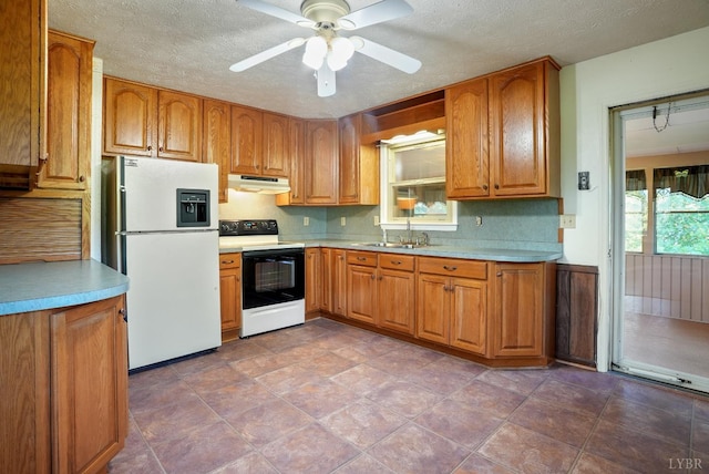 2294 High Peak Rd, Monroe, VA 24574 - kitchen featuring electric range oven, freestanding refrigerator, under cabinet range hood, brown cabinetry, and a textured ceiling
