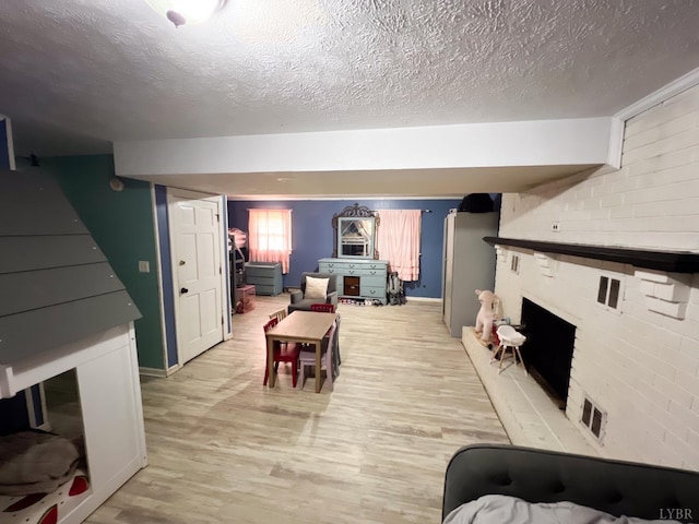 68 Cardwell Ln, Lynchburg, VA 24504 - living room with light wood finished floors, a textured ceiling, and a brick fireplace