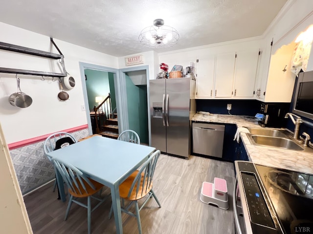 68 Cardwell Ln, Lynchburg, VA 24504 - kitchen featuring stainless steel appliances, light countertops, white cabinetry, light wood-style flooring, and a chandelier
