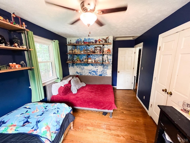 68 Cardwell Ln, Lynchburg, VA 24504 - bedroom featuring wood finished floors, a textured ceiling, a closet, and a ceiling fan