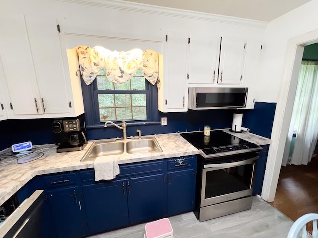 68 Cardwell Ln, Lynchburg, VA 24504 - kitchen with appliances with stainless steel finishes, blue cabinets, light countertops, white cabinets, and ornamental molding