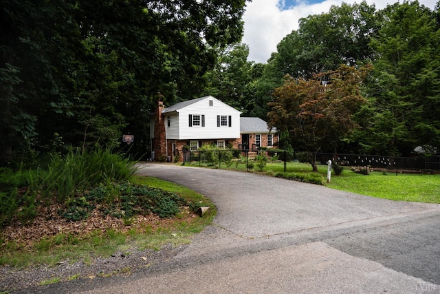 68 Cardwell Ln, Lynchburg, VA 24504 - tri-level home with a chimney, brick siding, and asphalt driveway