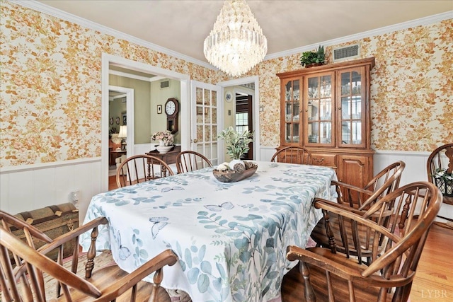 126 Arrowhead, Lynchburg, VA 24502 - dining area featuring wallpapered walls, a wainscoted wall, a chandelier, light wood-type flooring, and ornamental molding