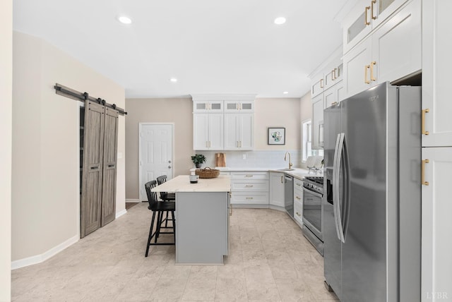 1505 Chestnut Grove Rd, Appomattox, VA 24522 - kitchen with appliances with stainless steel finishes, a barn door, a center island, a kitchen bar, and recessed lighting