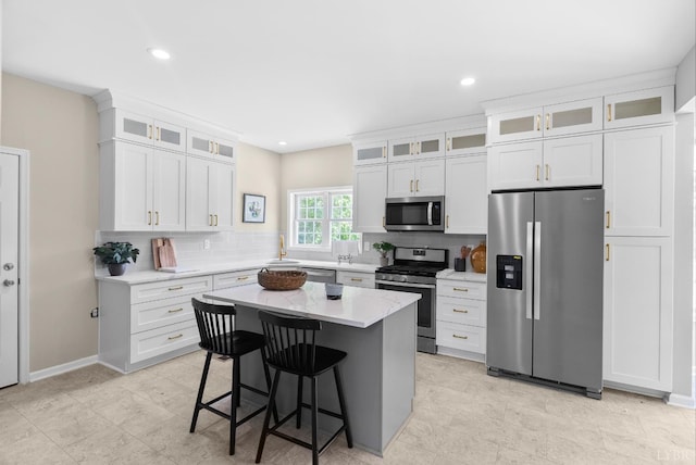 1505 Chestnut Grove Rd, Appomattox, VA 24522 - kitchen featuring stainless steel appliances, tasteful backsplash, a center island, a kitchen breakfast bar, and white cabinets