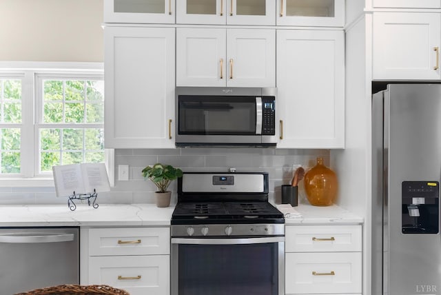 1505 Chestnut Grove Rd, Appomattox, VA 24522 - kitchen with appliances with stainless steel finishes, white cabinets, tasteful backsplash, and glass insert cabinets