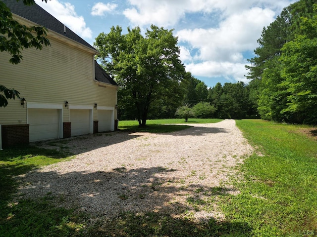 1505 Chestnut Grove Rd, Appomattox, VA 24522 - view of property exterior featuring a garage, gravel driveway, and brick siding