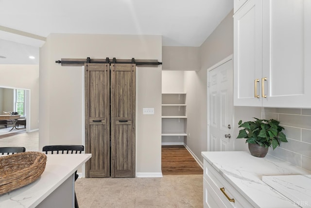 1505 Chestnut Grove Rd, Appomattox, VA 24522 - kitchen featuring light stone countertops, white cabinetry, a barn door, recessed lighting, and light tile patterned floors
