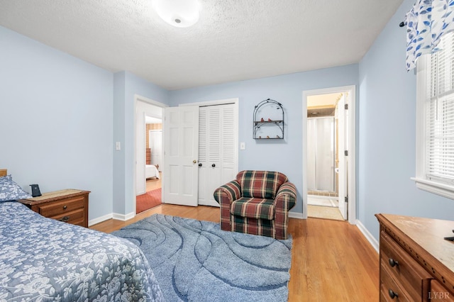 201 Windsor Rd, Lynchburg, VA 24502 - bedroom featuring light wood finished floors, a closet, a textured ceiling, and ensuite bathroom
