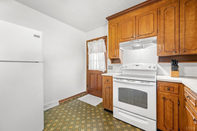 201 Windsor Rd, Lynchburg, VA 24502 - kitchen featuring white appliances, under cabinet range hood, light countertops, dark floors, and backsplash