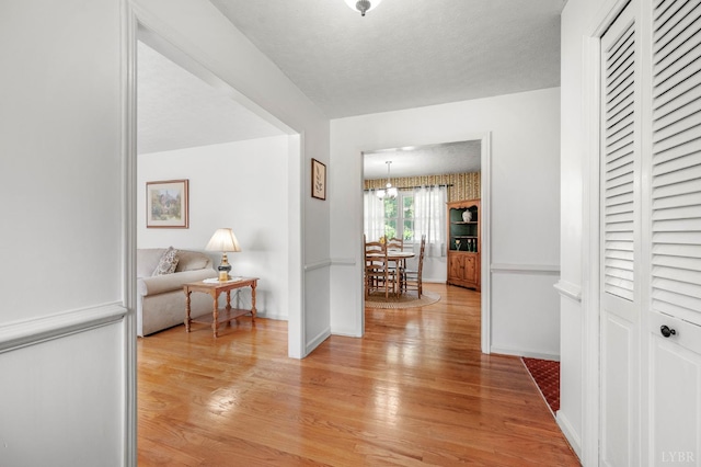 201 Windsor Rd, Lynchburg, VA 24502 - corridor with light wood-style floors and a chandelier