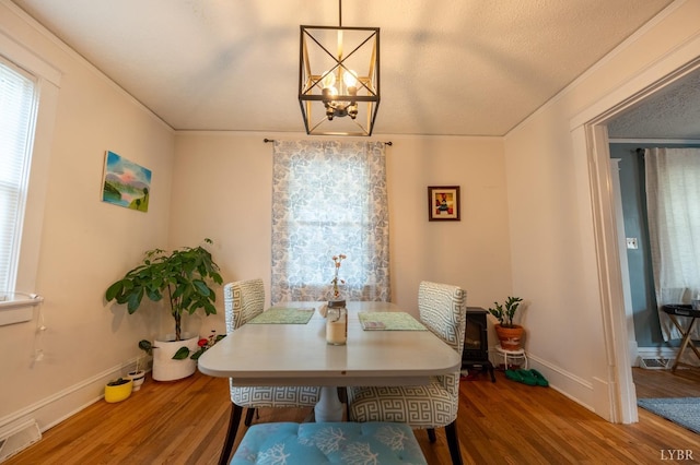 3040 Forest Hills Cir, Lynchburg, VA 24501 - dining room with wood finished floors, a chandelier, and crown molding