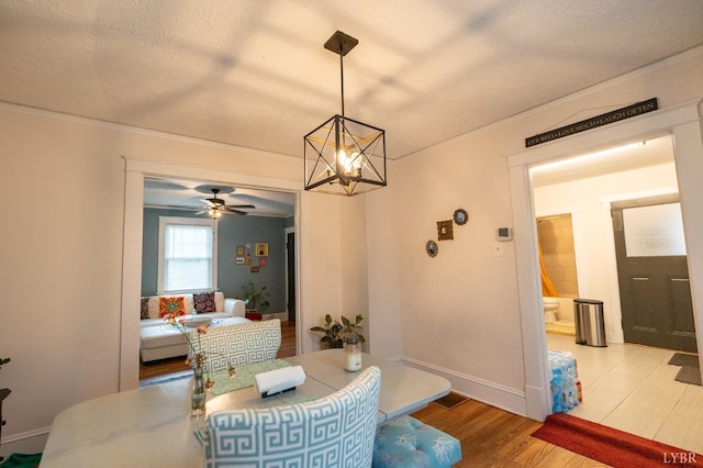 3040 Forest Hills Cir, Lynchburg, VA 24501 - dining space with ornamental molding, a chandelier, wood finished floors, a textured ceiling, and a ceiling fan