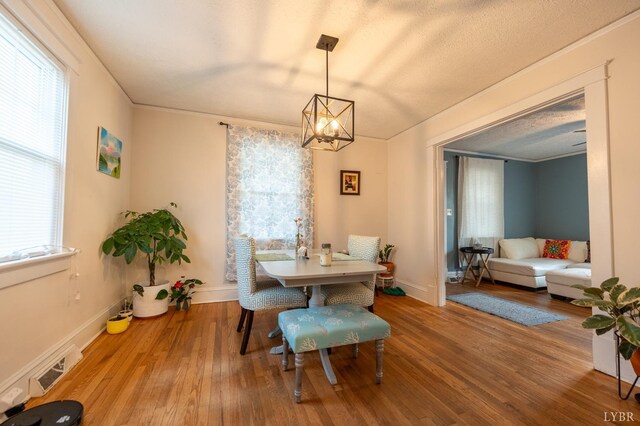 3040 Forest Hills Cir, Lynchburg, VA 24501 - dining room with plenty of natural light, a chandelier, wood finished floors, and ornamental molding