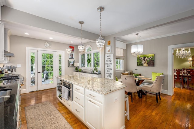 1517 Linden Ave, Lynchburg, VA 24503 - kitchen with a chandelier, wood finished floors, healthy amount of natural light, under cabinet range hood, and recessed lighting