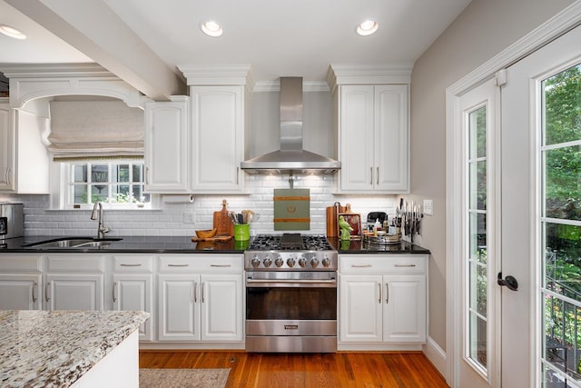 1517 Linden Ave, Lynchburg, VA 24503 - kitchen featuring high end stainless steel range oven, wall chimney range hood, light wood-type flooring, white cabinets, and recessed lighting