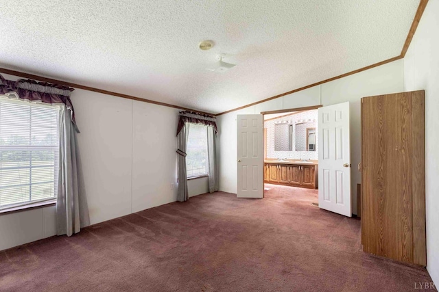 7026 Midway Rd, Phenix, VA 23959 - unfurnished bedroom with ornamental molding, vaulted ceiling, a textured ceiling, and carpet flooring