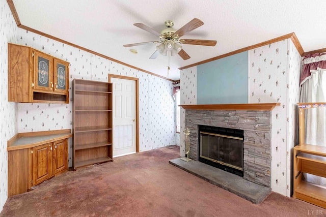 7026 Midway Rd, Phenix, VA 23959 - unfurnished living room featuring wallpapered walls, ornamental molding, carpet, ceiling fan, and a stone fireplace
