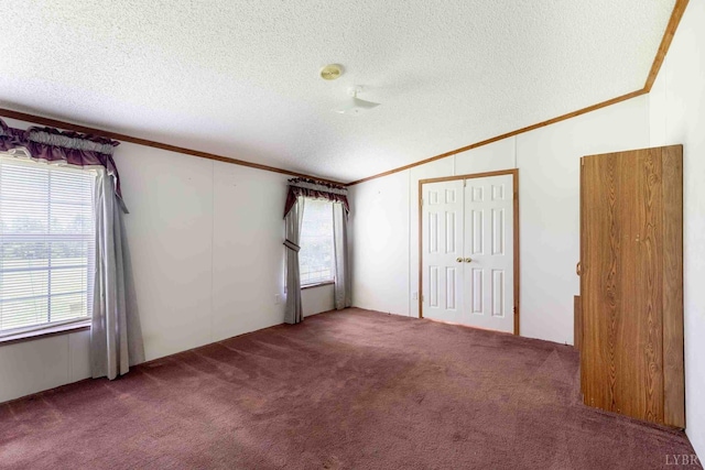 7026 Midway Rd, Phenix, VA 23959 - unfurnished bedroom featuring vaulted ceiling, a textured ceiling, crown molding, carpet, and a closet