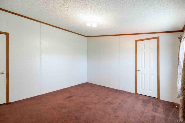 7026 Midway Rd, Phenix, VA 23959 - carpeted spare room featuring crown molding, a decorative wall, and a textured ceiling