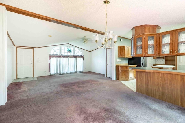 7026 Midway Rd, Phenix, VA 23959 - kitchen with brown cabinets, freestanding refrigerator, lofted ceiling, a chandelier, and light colored carpet
