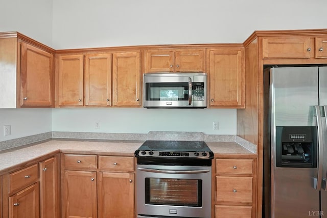1433 Piney Mountain Rd, Appomattox, VA 24522 - kitchen featuring stainless steel appliances, light countertops, and brown cabinets