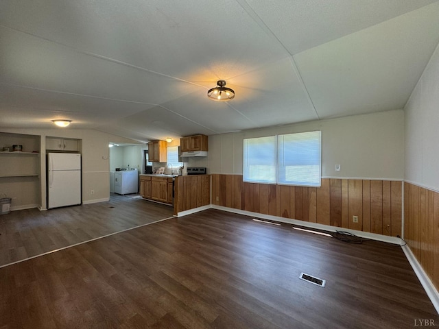 3687 Old Grist Mill Rd, Appomattox, VA 24522 - unfurnished living room featuring washer / dryer, dark wood-style floors, lofted ceiling, wooden walls, and wainscoting