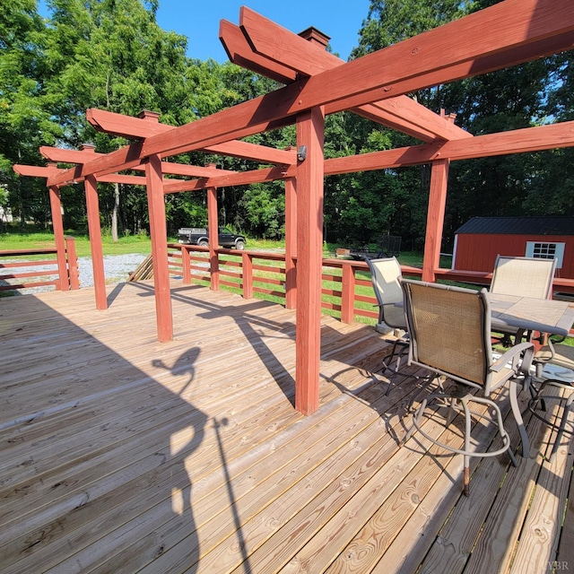 509 Meadowbrook Ln, Rustburg, VA 24588 - wooden terrace featuring outdoor dining space, view of wooded area, and an outdoor structure