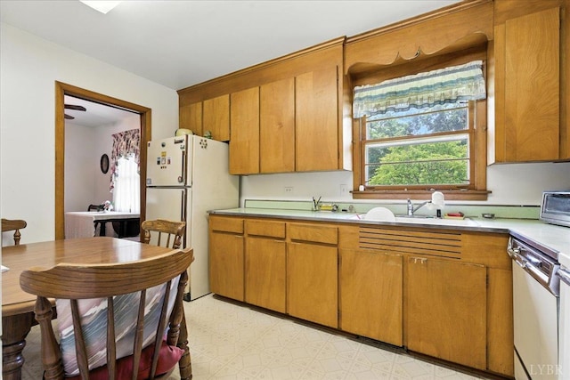 4317 Montgomery Rd, Lynchburg, VA 24503 - kitchen featuring white appliances, light countertops, and brown cabinetry