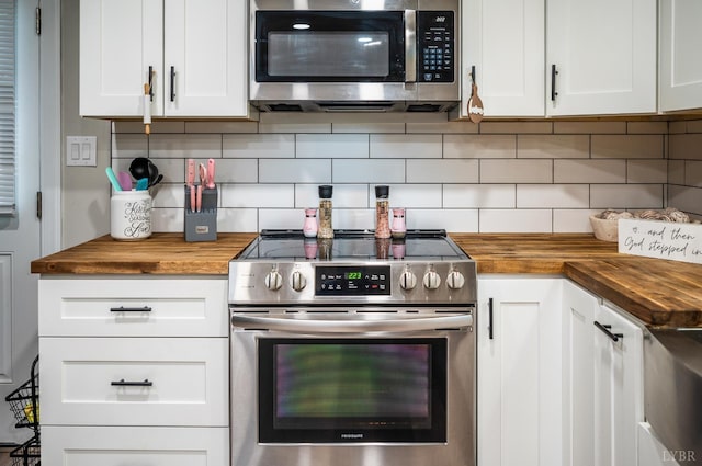 387 Stage Rd, Amherst, VA 24521 - kitchen featuring appliances with stainless steel finishes, butcher block counters, decorative backsplash, and white cabinetry
