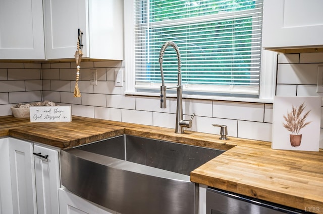 387 Stage Rd, Amherst, VA 24521 - kitchen featuring wooden counters, tasteful backsplash, stainless steel dishwasher, and white cabinetry