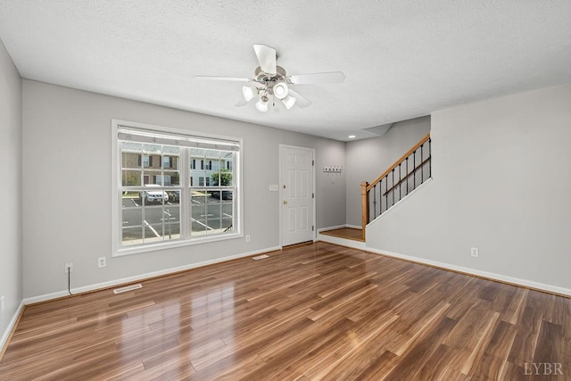 1036 Middle View Dr, Forest, VA 24551 - entryway with wood finished floors, stairway, a ceiling fan, and a textured ceiling